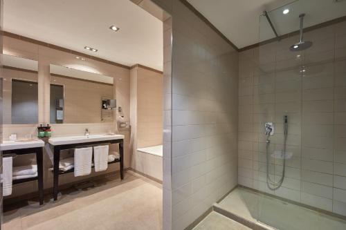 a bathroom with two sinks and a shower at Crowne Plaza Verona Fiera by IHG in Verona