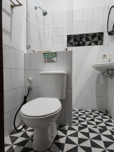 a bathroom with a toilet and a sink at Domore Lifestyle in Jetis
