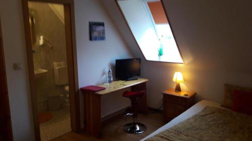 TV a/nebo společenská místnost v ubytování Gasthof Altes Farmhaus und Apartment