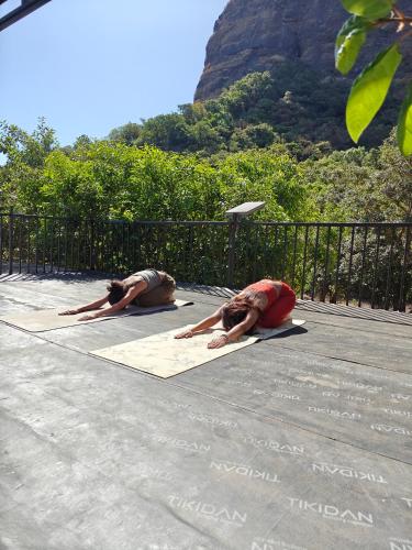 two people laying on a yoga mat on the ground at Gaia Ekole in Āmbavna