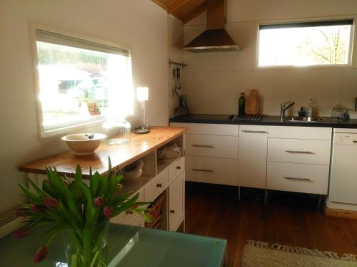 a kitchen with white cabinets and a counter top at Holiday home Giethmen in Giethmen