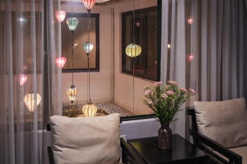 a room with a table and chairs and lights at La Passion Classic Hotel in Hanoi