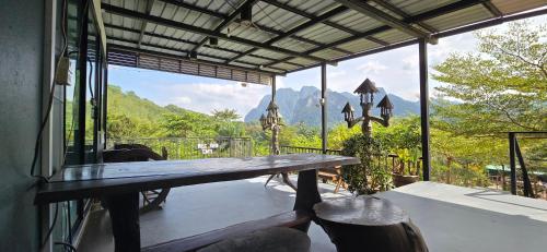 a table on a balcony with a view of the mountains at Khao Sok Horizon in Ban Bang Thong
