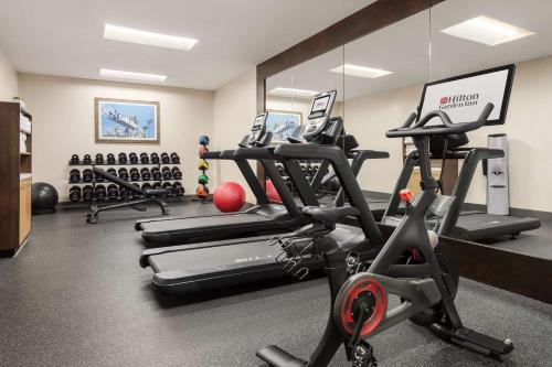 a gym with several treadmills and exercise bikes at Hilton Garden Inn Carlsbad Beach in Carlsbad