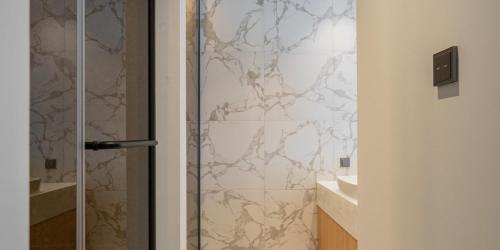 a shower with a glass door in a bathroom at The hound hotel bandalseom2 in Ansan