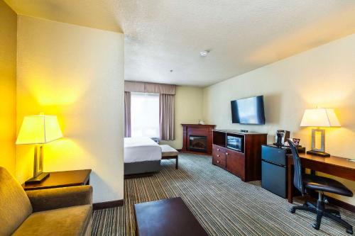 a hotel room with a bed and a desk at Quality Inn & Suites Yorkton in Yorkton