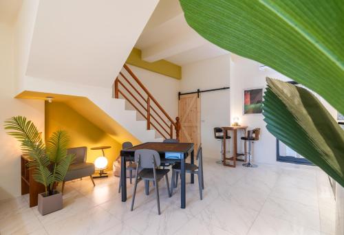 a dining room with a table and chairs and a staircase at 歸巢民宿 Homecoming in Jiaoxi