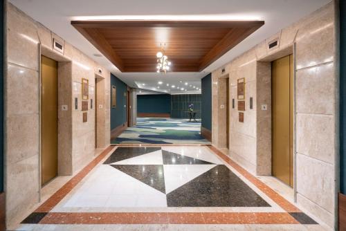 a hallway in a building with a black and white tile floor at Hilton Porto Alegre, Brazil in Porto Alegre