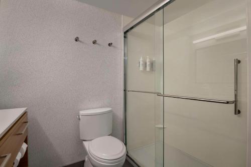 a bathroom with a toilet and a glass shower at Home2 Suites By Hilton Sanford Orlando North in Sanford
