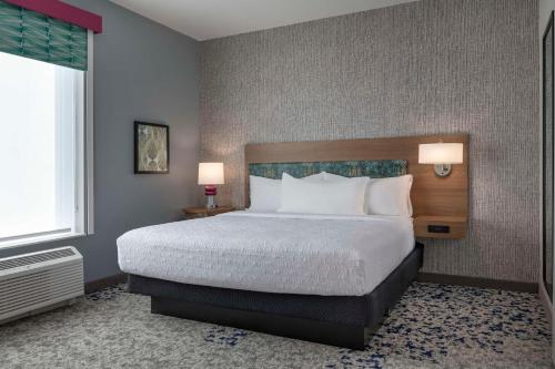 a hotel room with a bed and a window at Home2 Suites By Hilton Sanford Orlando North in Sanford