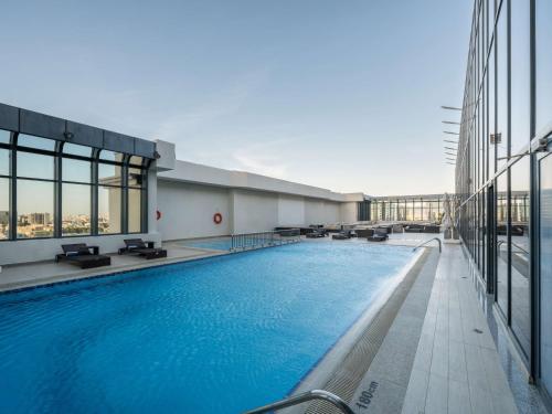 a large swimming pool on the top of a building at The Hotel Galleria Jeddah, Curio Collection by Hilton in Jeddah