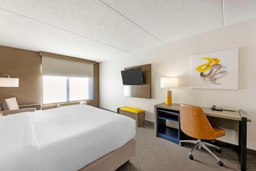 a hotel room with a bed and a desk with a computer at Comfort Inn & Suites Arlington Heights - Schaumburg in Arlington Heights