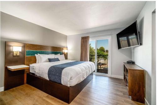 a hotel room with a bed and a television at MainStay Suites Moreno Valley Near March Air Reserve Base in Moreno Valley