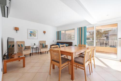 a dining room with a table and chairs at Comfortable Duplex Apartment with 2 bedrooms & 2 terraces 200 m away from the Ocean in Porches