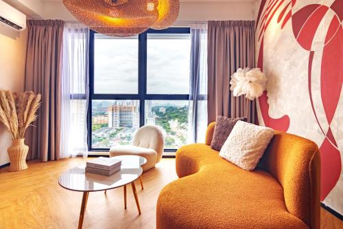 a living room with a couch and a table at Urban Suites, Signature Collection by Stellar ALV in Jelutong