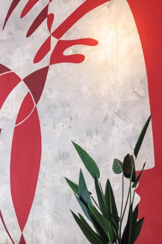 a painting of a plant in front of a wall at Urban Suites, Signature Collection by Stellar ALV in Jelutong