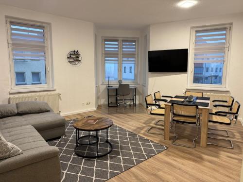 a living room with a couch and a table at Gemütliche Wohnung direkt am Bahnhof perfekte Lage in Bitterfeld
