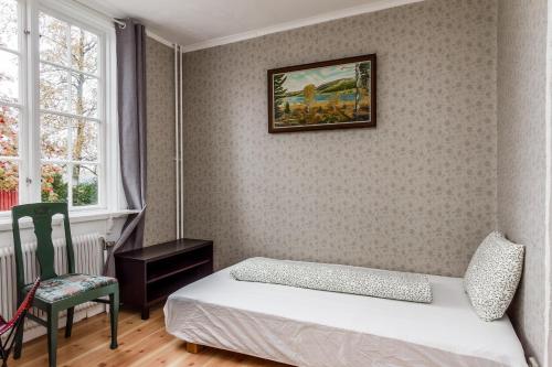 a bedroom with a bed and a picture on the wall at Central Lakefront Retreat in Hagfors