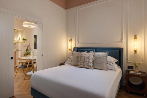 a bedroom with a large white bed with pillows at Villa Albi - Machne Yehuda Hotel in Jerusalem