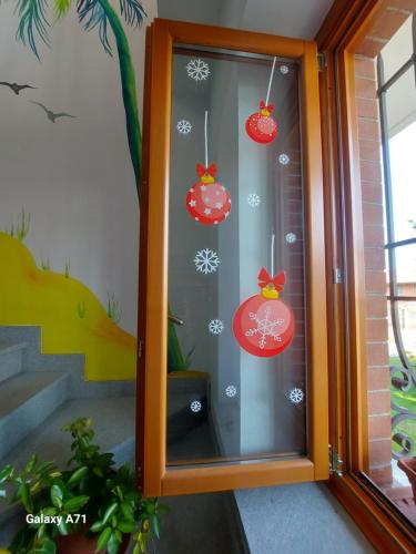 a glass door with christmas ornaments on it at Casa Matilde in Leinì