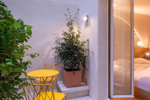 a room with a table and chairs and a bed at Arc Elysées in Paris