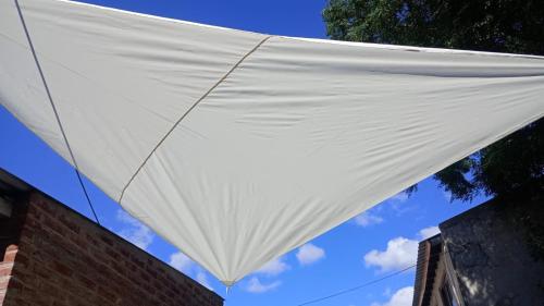 a white kite hanging from the side of a building at La casita en San Miguel del Monte in San Miguel del Monte
