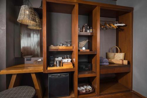 a wooden book shelf with products in it at Silavadee Pool Spa Resort - SHA Extra Plus in Lamai