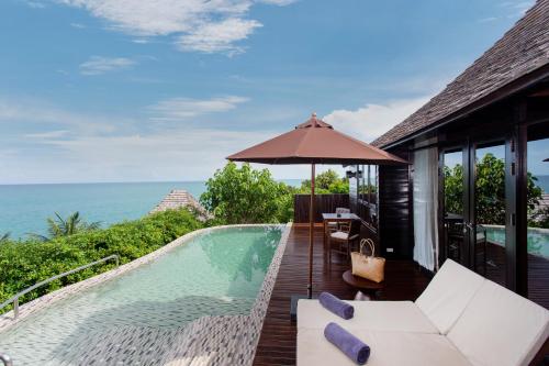 a resort with a swimming pool and an umbrella at Silavadee Pool Spa Resort - SHA Extra Plus in Lamai