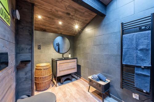 a bathroom with a mirror and a dresser and a sink at Bienvenue Chez Les Trutes in Modane