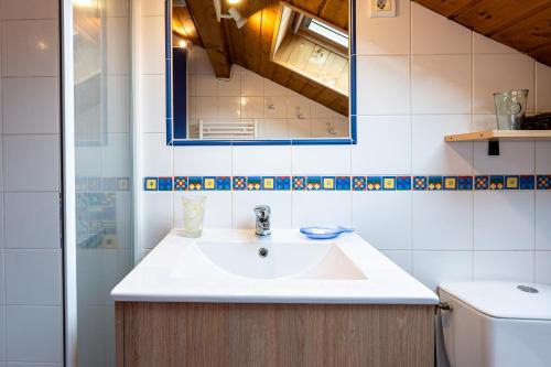 a bathroom with a sink and a mirror at chalet pierre et bois in Aigueblanche