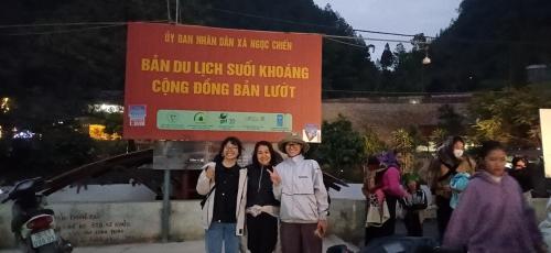 a group of people standing in front of a sign at Ngoc Chien Pearl in Ngọc Chiến