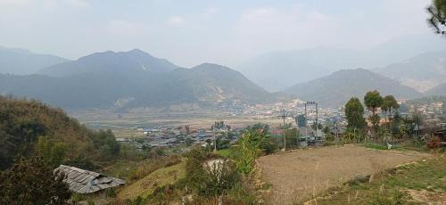 a town on a hill with mountains in the background at Ngoc Chien Pearl in Ngọc Chiến