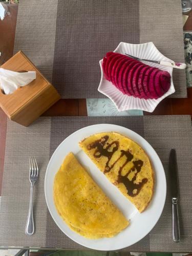 a plate with a piece of food on a table at Tam Coc Lotus Flower Homestay in Ninh Binh