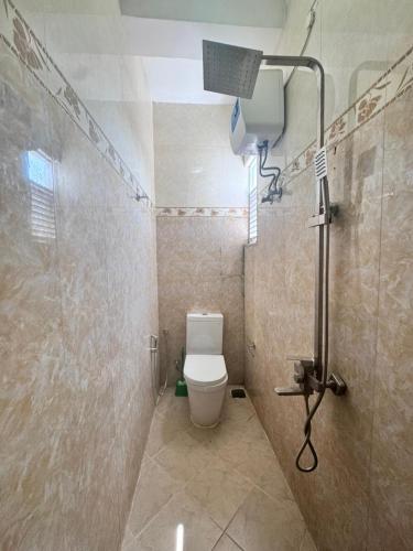 a bathroom with a shower and a toilet in it at Colombo Apartments Dehiwela in Dehiwala