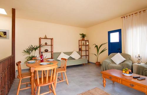 a living room with a table and a couch at Casa del Rio in Caleta de Sebo