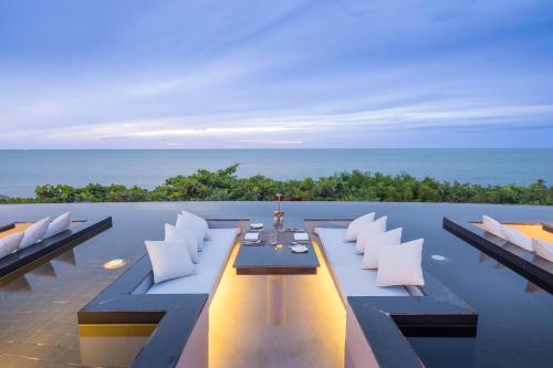 an outdoor dining area with a view of the ocean at Silavadee Pool Spa Resort - SHA Extra Plus in Lamai