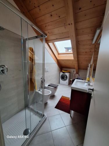 a bathroom with a shower and a toilet and a sink at Casa Matilde in Leinì
