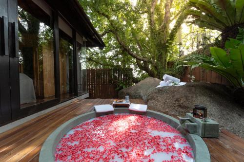 a large red rug sitting on a wooden deck at Silavadee Pool Spa Resort - SHA Extra Plus in Lamai