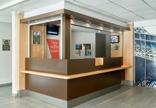 a display case in a building with a mirror at B&B HOTEL Orly Rungis Aéroport 2 étoiles in Rungis