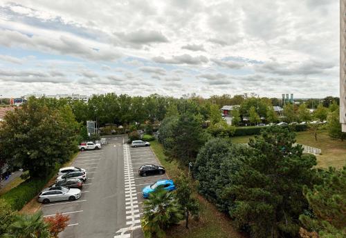 an aerial view of a parking lot with cars parked at B&B HOTEL Orly Rungis Aéroport 2 étoiles in Rungis