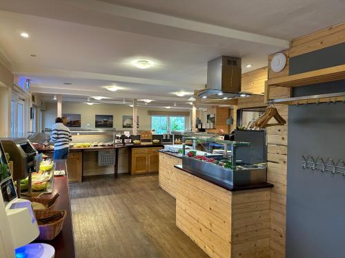 a large kitchen with a person standing in the kitchen at Schwedenhaus Wismar in Wismar