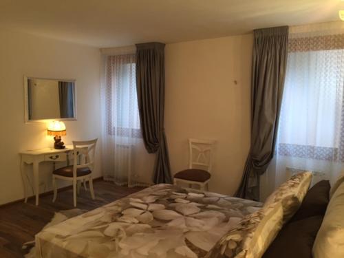 a bedroom with a large bed and a desk and windows at Nausicaa in Venice