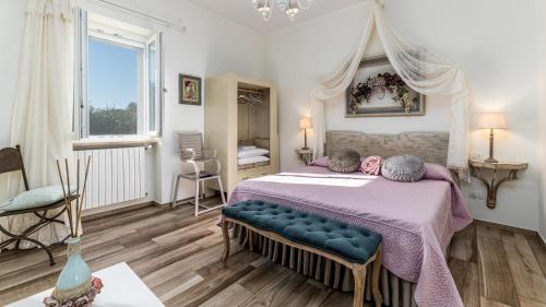 a bedroom with a large bed with a purple blanket at VILLA RUDY 8, Emma Villas in Padresergio