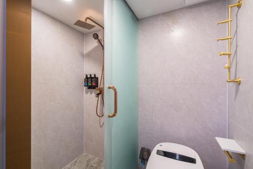a bathroom with a shower with a toilet in it at De quan Hotel Free breakfast and lunch are provided Coffee beverages andsnacks are available in the lobby Free access to the gym and laundry room Located in the city center, near Shifoying in Beijing