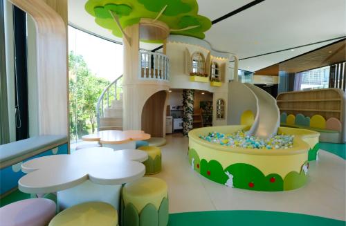 a childrens play room with a tree house at Golden Tulip Holland Resort Batu in Batu