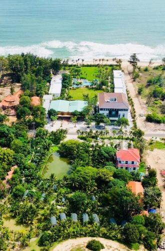 an aerial view of a resort near the ocean at The Vista Beach Resort Phan Thiết in Phan Thiet