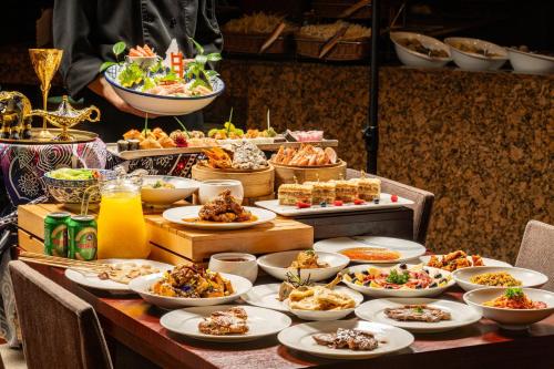 a table filled with plates of food and bowls of food at Marco Polo Xiamen in Xiamen