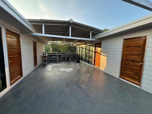 an empty deck with a table and chairs on a house at 4 - Private Villa 2BR 1000mbps Wi-Fi in Wok Tum