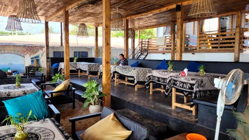 a restaurant with tables and chairs in a room at Silent Waves in Agonda
