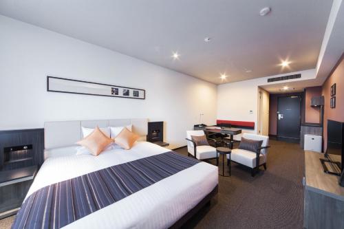 a hotel room with a bed and a desk at HOTEL MYSTAYS PREMIER Kanazawa in Kanazawa
